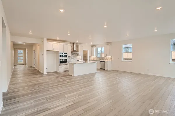 a kitchen with stainless steel appliances kitchen island granite countertop a stove and a refrigerator