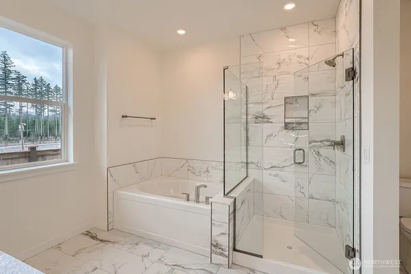 a bathroom with a granite countertop sink a toilet and mirror