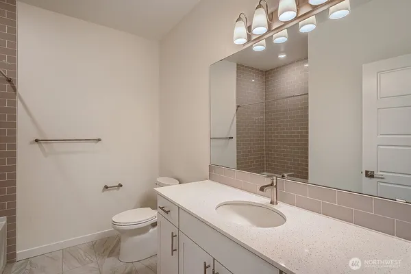 a view of an empty room with wooden floor and closet