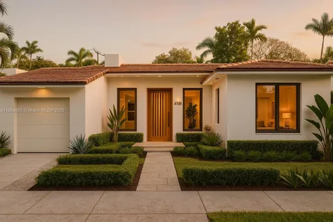 a view of a house with a small yard and plants
