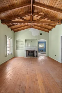 a view of a livingroom with a fireplace and window