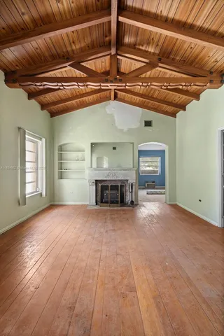 a view of a livingroom with a fireplace and window