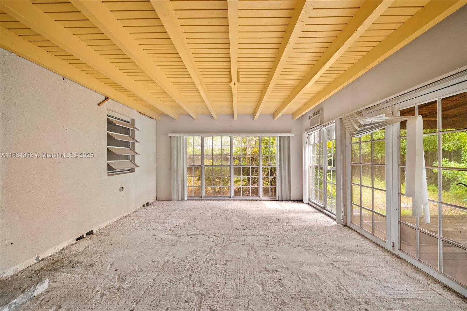 531 Northeast 55th Terrace Miami, FL 33137 - Photo 9 of 15 a view of an empty room with a sliding door