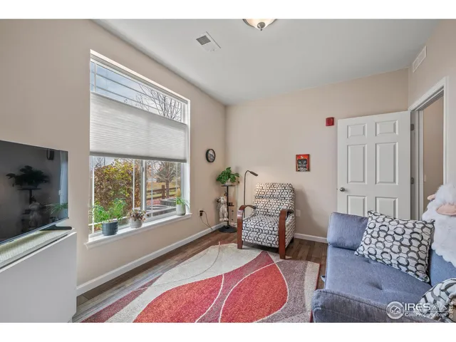 a bedroom with furniture and a large window