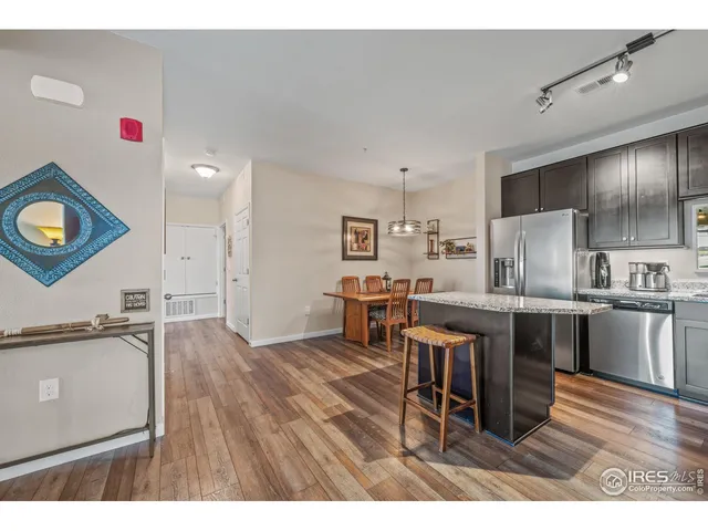 a living room with stainless steel appliances kitchen island granite countertop furniture and a kitchen view