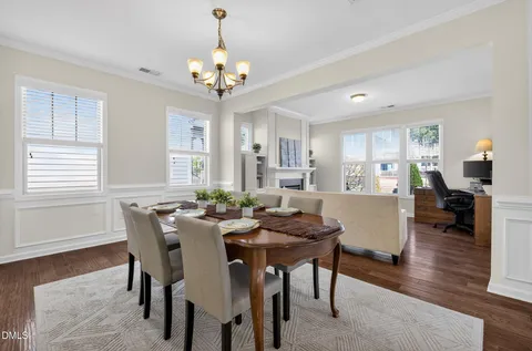 a view of a dining room with furniture window and wooden floor