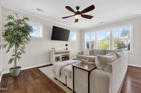 a living room with stainless steel appliances granite countertop furniture a couch and a view of kitchen