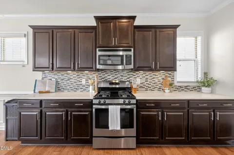 a kitchen with refrigerator and cabinets