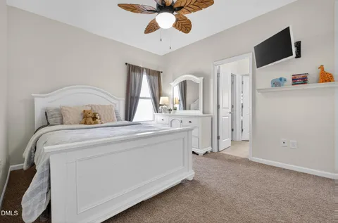 a bedroom with a bed and flat screen tv