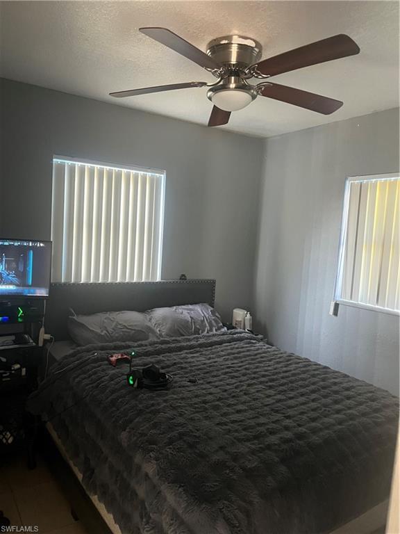 101 East Jersey Road Lehigh Acres, FL 33936 - Photo 5 of 10 a bedroom with a bed dresser and a window