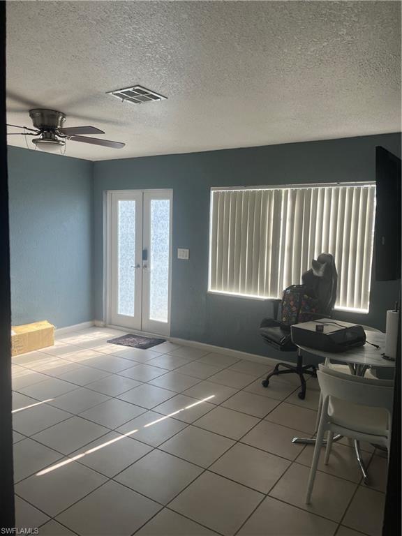 101 East Jersey Road Lehigh Acres, FL 33936 - Photo 7 of 10 a view of a livingroom with workspace and a window