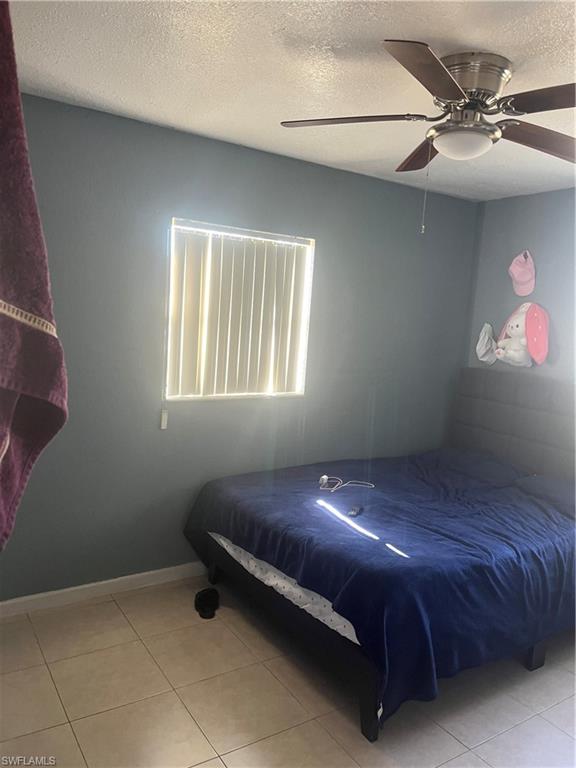 101 East Jersey Road Lehigh Acres, FL 33936 - Photo 9 of 10 a bed sitting in a bedroom next to a window