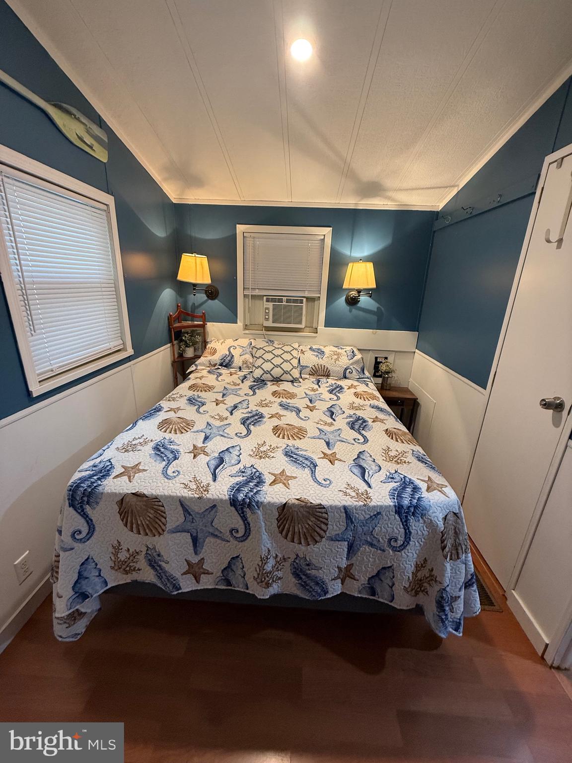 515 Corsons Tavern Road, Unit J3 Ocean View, NJ 08230 - Photo 5 of 15 a bedroom with a bed and a dresser with rug