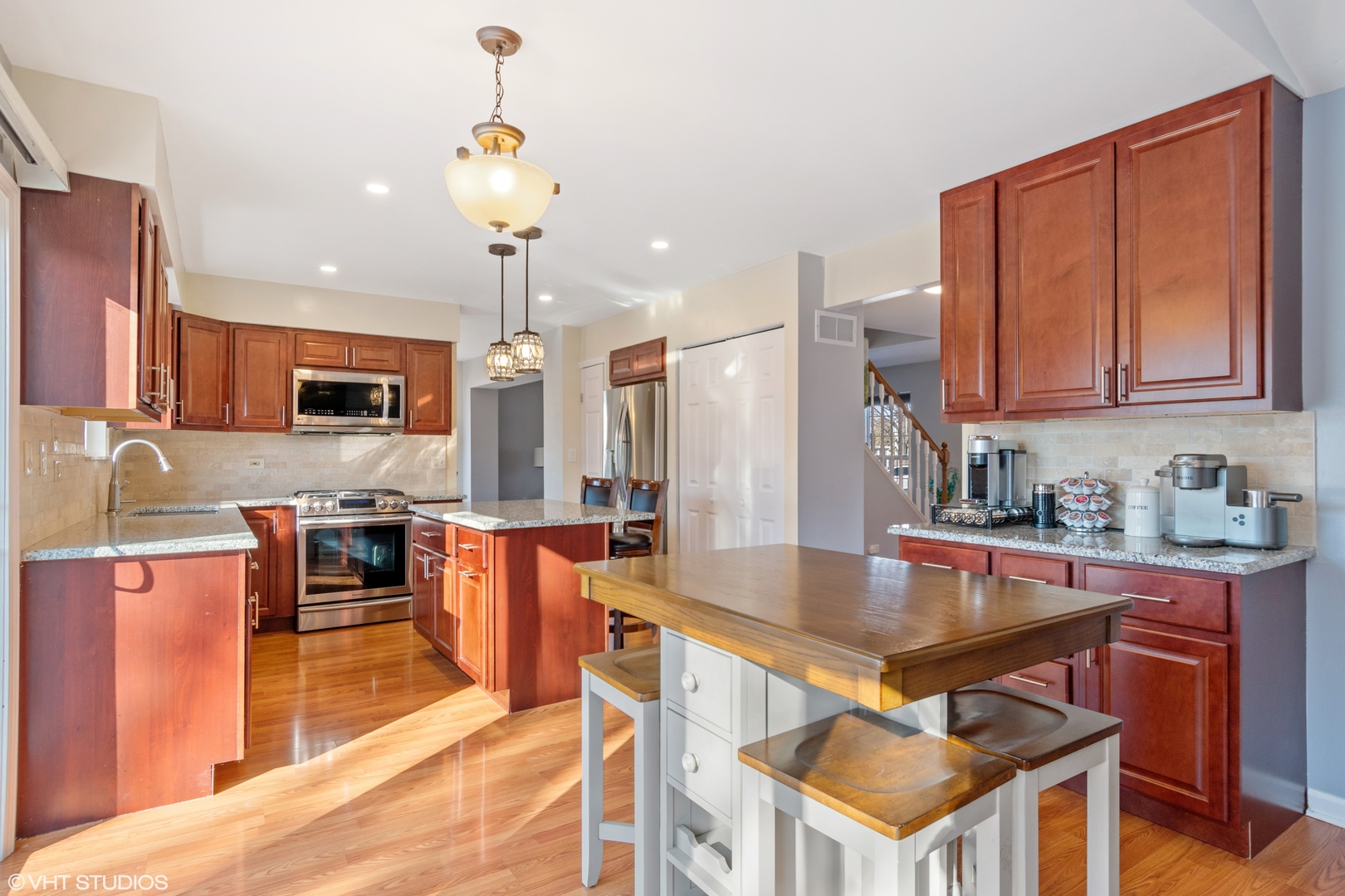 579 Buckboard Road Bolingbrook, IL 60490 - Photo 6 of 17 a kitchen with stainless steel appliances granite countertop a stove top oven a sink dishwasher and a table with chairs