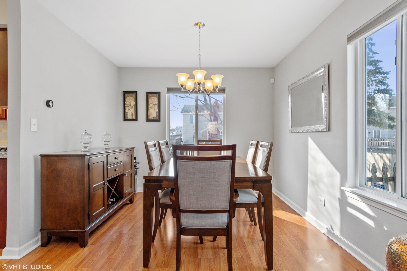 579 Buckboard Road Bolingbrook, IL 60490 - Photo 8 of 17 a dining room with furniture a chandelier and wooden floor