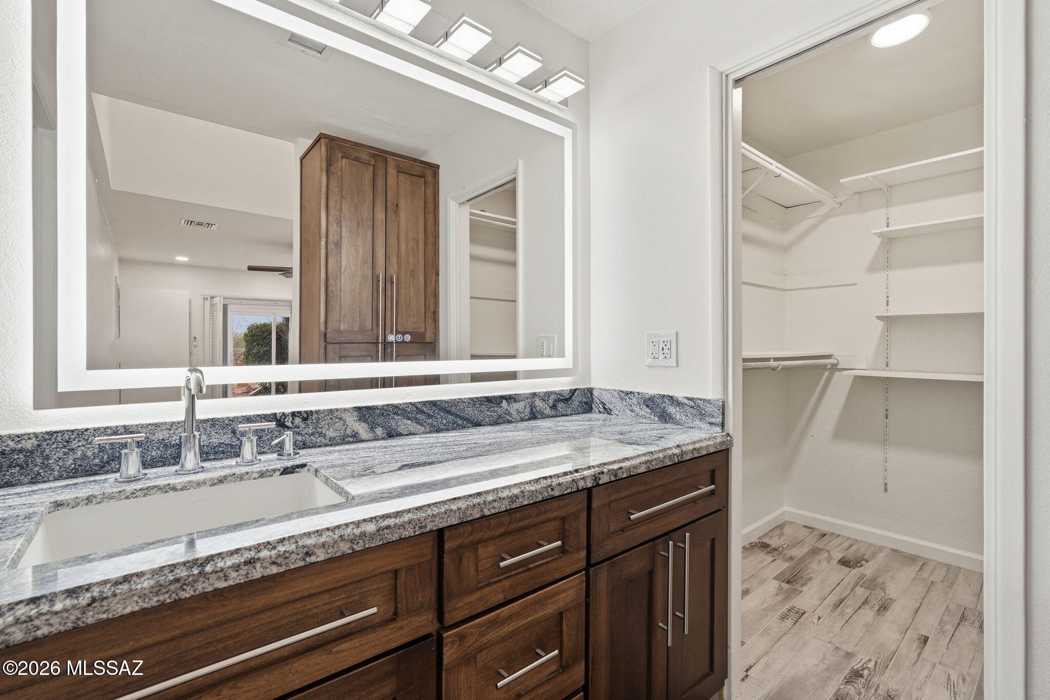 1183 Circulo Canario Rio Rico, AZ 85648 - Photo 12 of 31 a bathroom with a granite countertop sink and a mirror