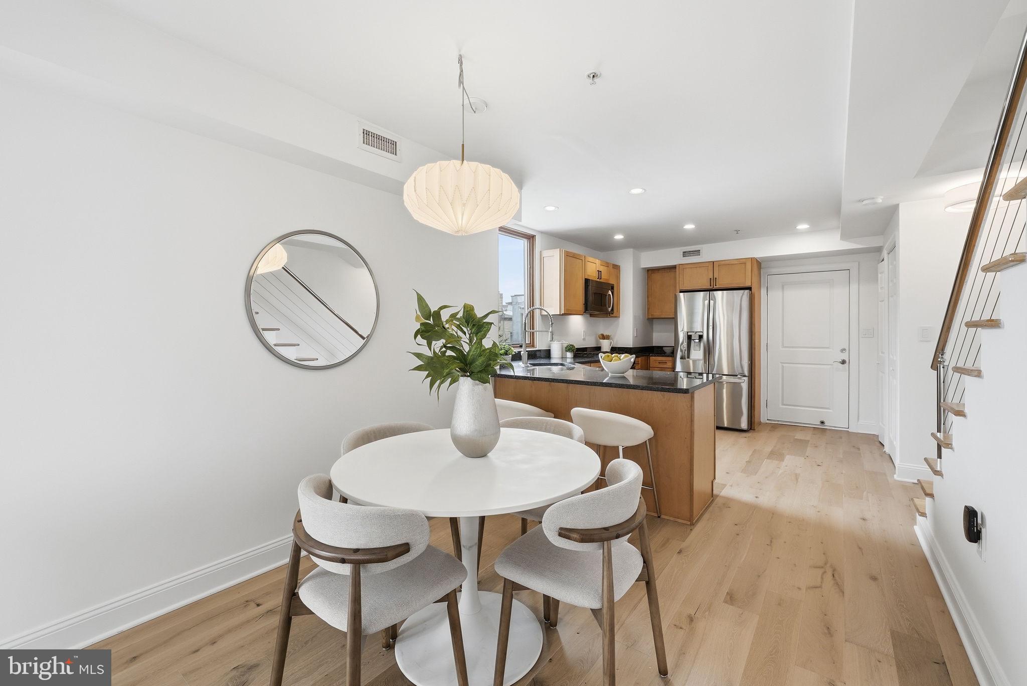 2713 Ontario Road Northwest, Unit 5 Washington, DC 20009 - Photo 11 of 35 a kitchen with stainless steel appliances kitchen island a table and chairs in it