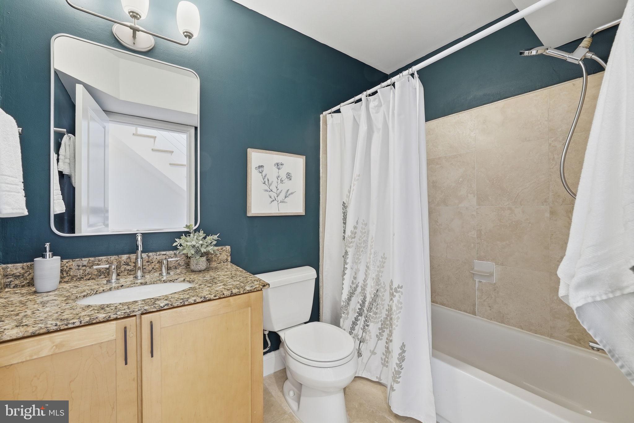 2713 Ontario Road Northwest, Unit 5 Washington, DC 20009 - Photo 21 of 35 a bathroom with a granite countertop sink toilet and shower