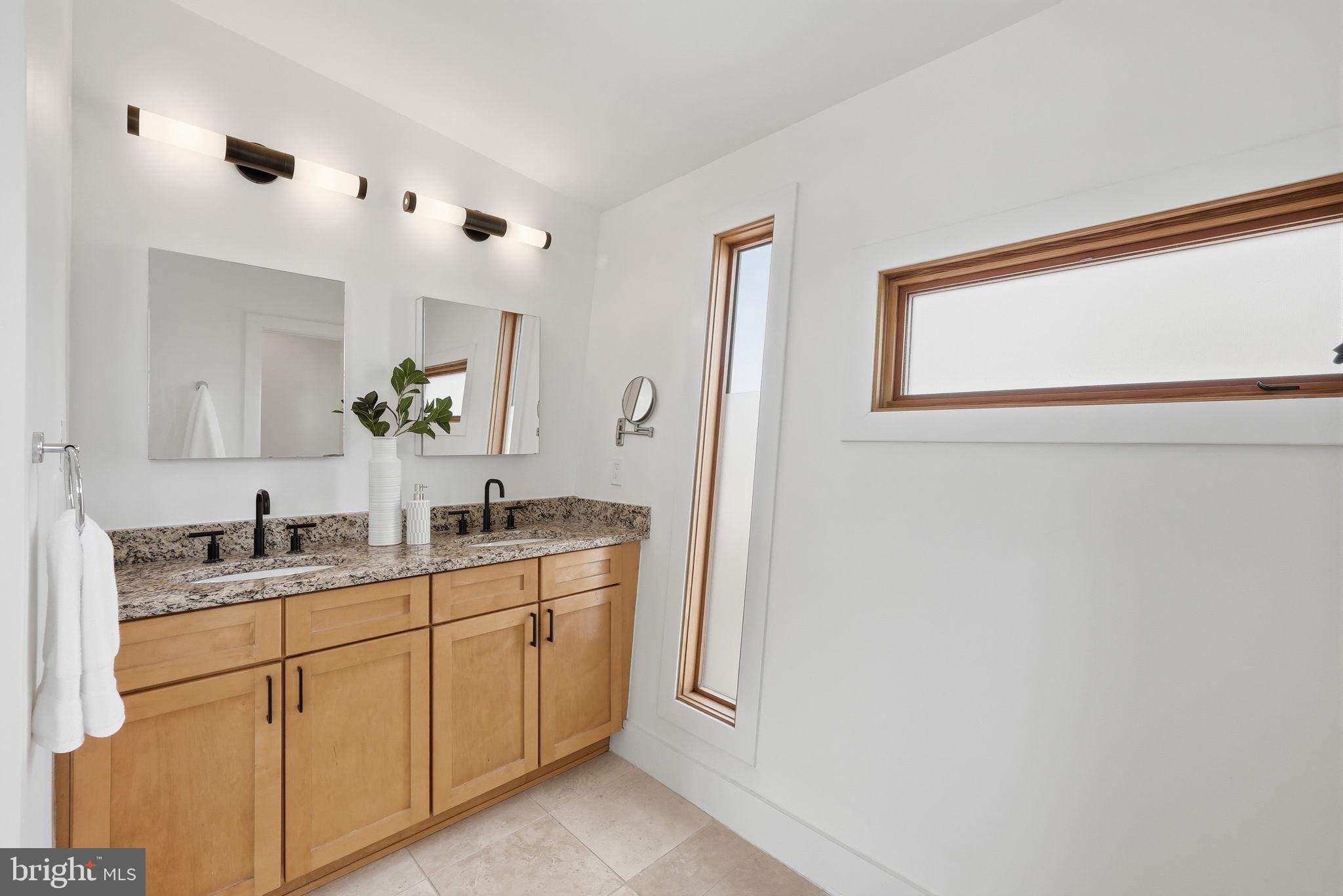 2713 Ontario Road Northwest, Unit 5 Washington, DC 20009 - Photo 27 of 35 a bathroom with a double vanity sink and mirror