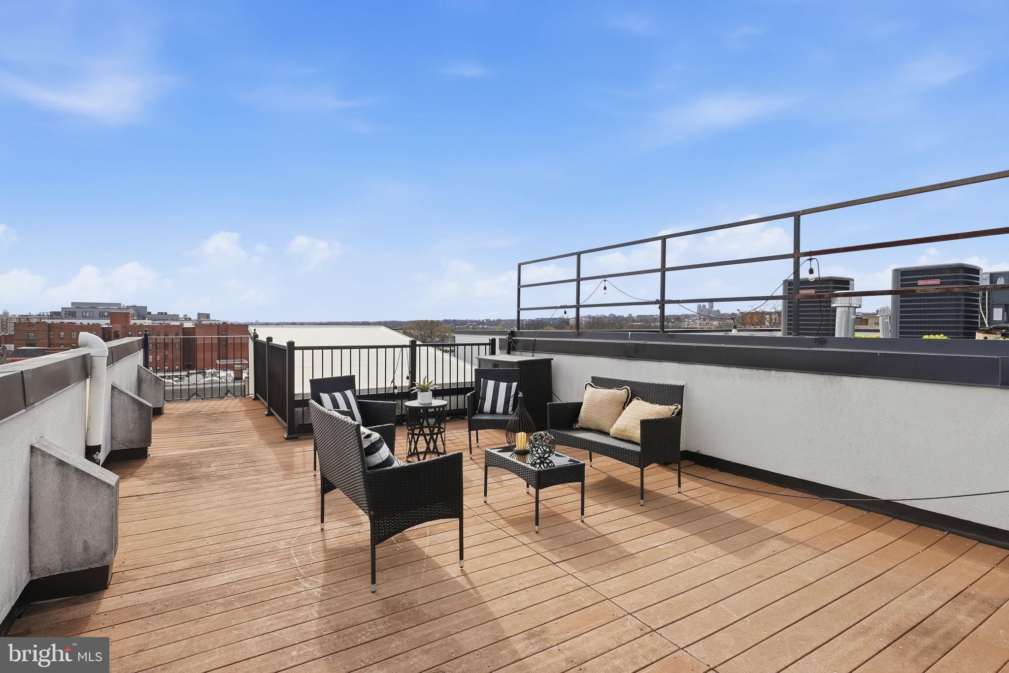 2713 Ontario Road Northwest, Unit 5 Washington, DC 20009 - Photo 31 of 35 a roof deck with a table and chairs