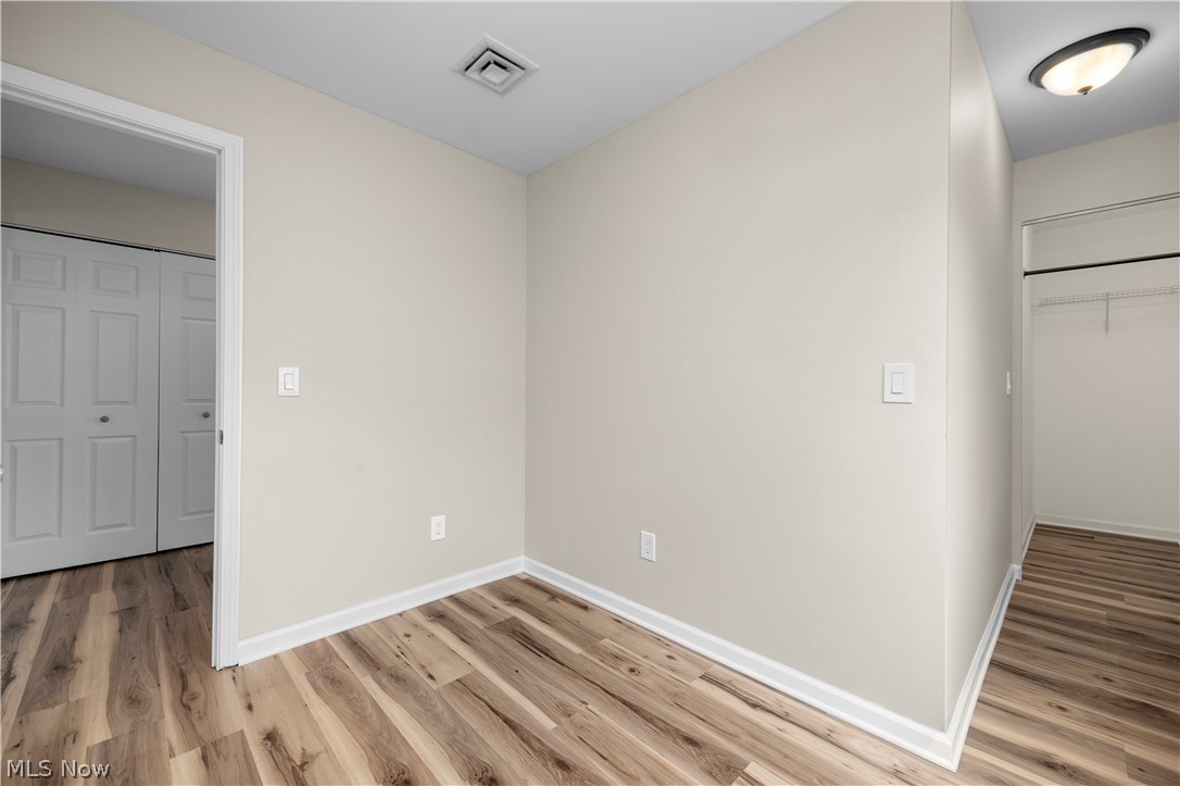 12452 Island Road Grafton, OH 44044 - Photo 8 of 39 Unfurnished bedroom with light wood-style floors and baseboards