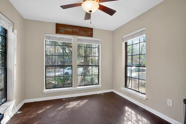 a view of a dining room with furniture and a window