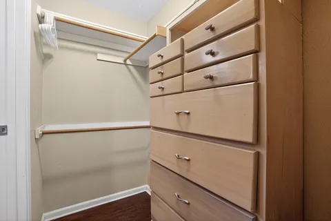 a living room with furniture a large window and a table