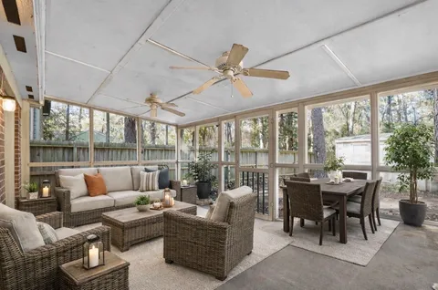 a view of a house with a yard and large tree
