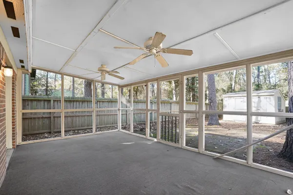 a view of a yard in front of a house with large trees
