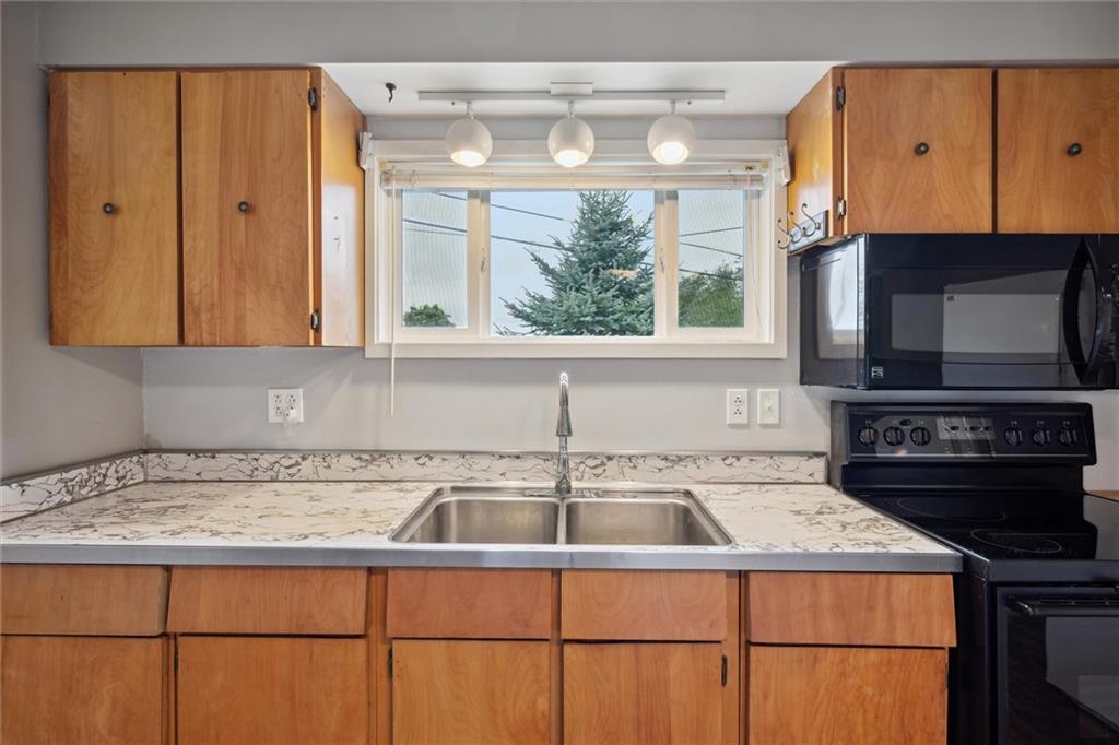 1662 Freeport Road Kittanning, PA 16201 - Photo 13 of 43 a kitchen with stainless steel appliances granite countertop a sink a stove and a microwave