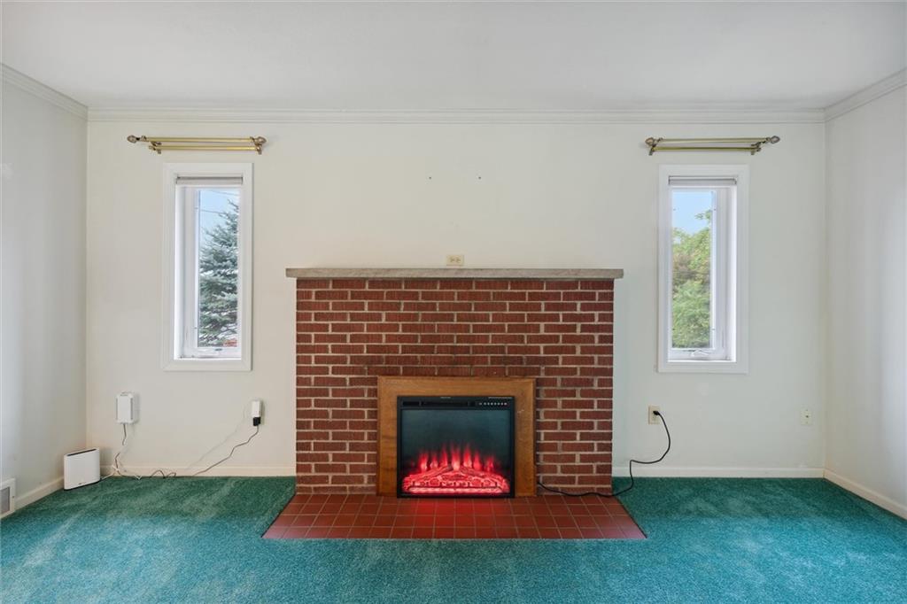 1662 Freeport Road Kittanning, PA 16201 - Photo 9 of 43 an empty room with fireplace and window