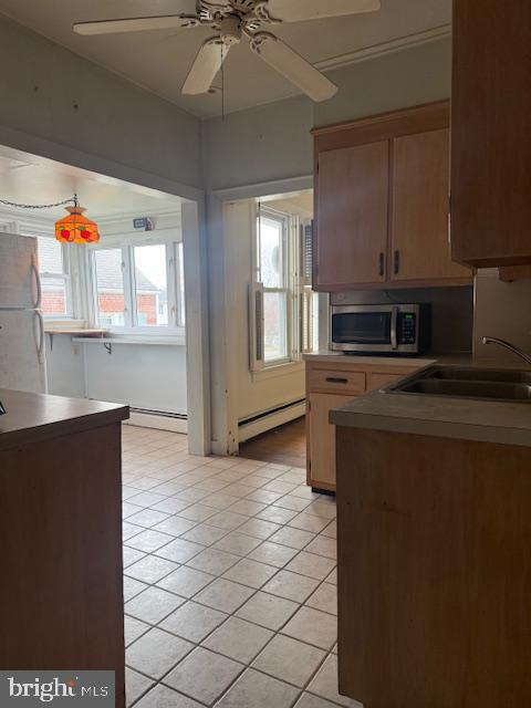 418 Church Street New Windsor, MD 21776 - Photo 8 of 20 a kitchen with stainless steel appliances a sink a stove a refrigerator cabinets and a dining table