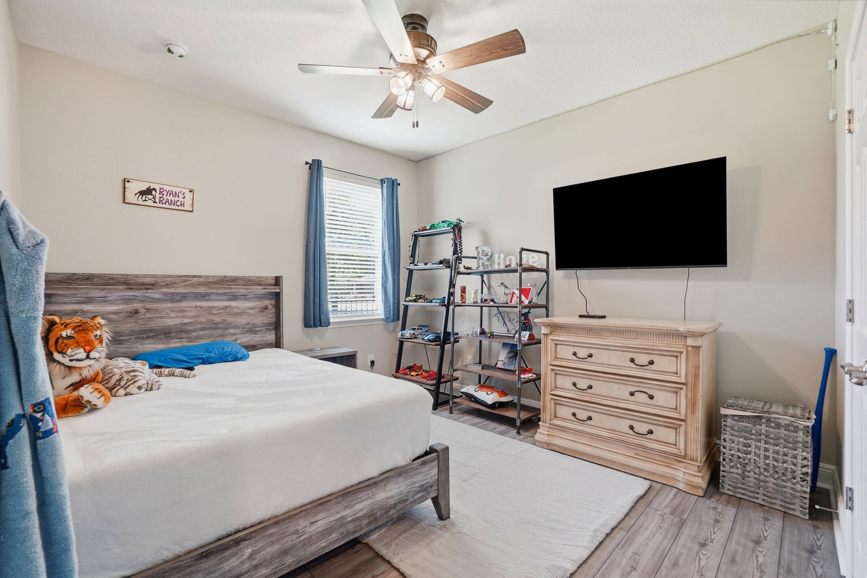 525 Windchime Way Freeport, FL 32439 - Photo 23 of 59 a bedroom with a bed and flat screen tv