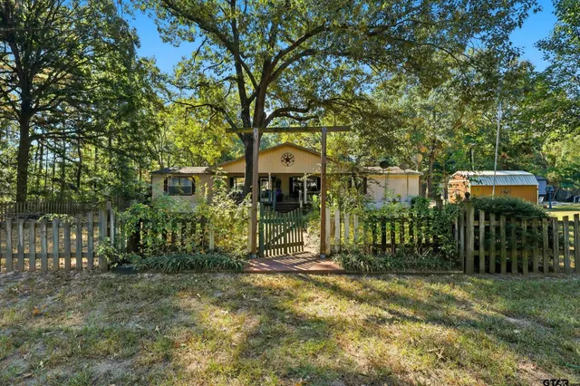 a view of a house with a small yard and plants