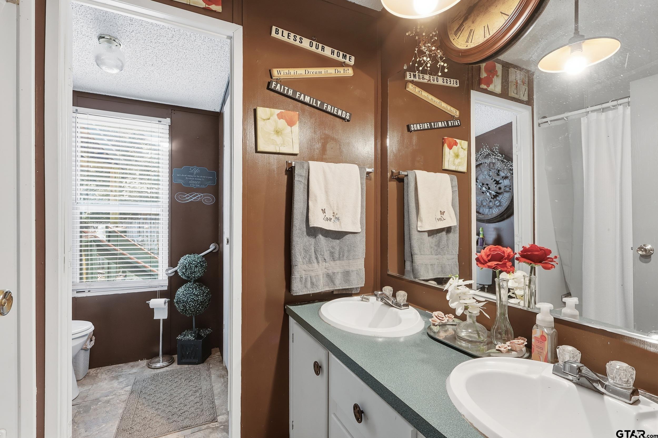 264 County Road 2169 Quitman, TX 75783 - Photo 1 of 34 a bathroom with a sink double vanity and a mirror