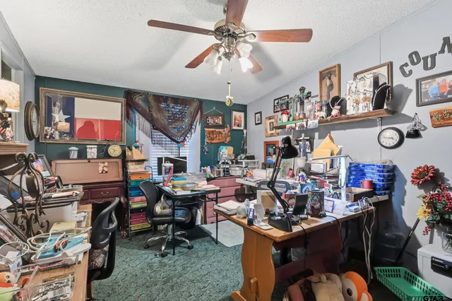 a view of a room with workspace and a window