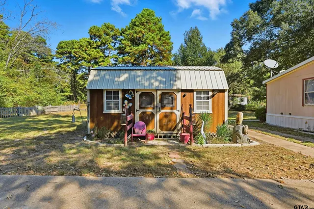 a view of a house with a yard and tree