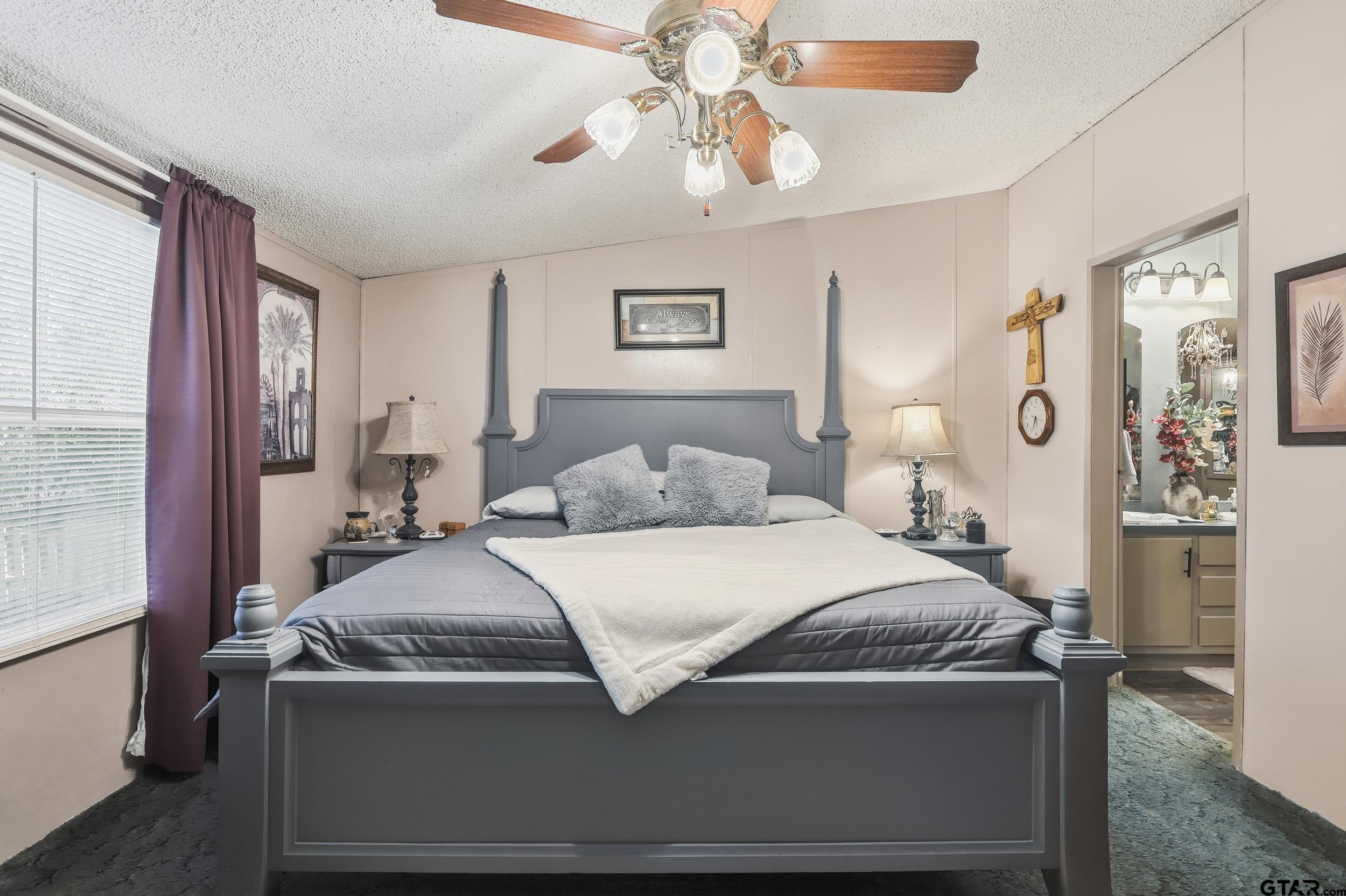 264 County Road 2169 Quitman, TX 75783 - Photo 32 of 34 a bedroom with a bed and a chandelier