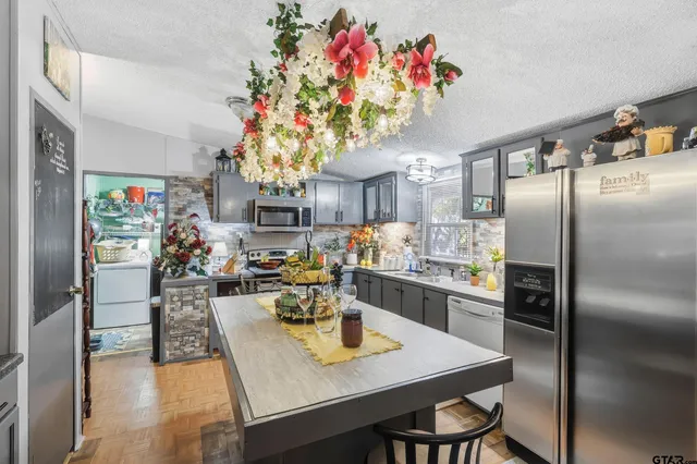 a view of a dining room with a table and chairs