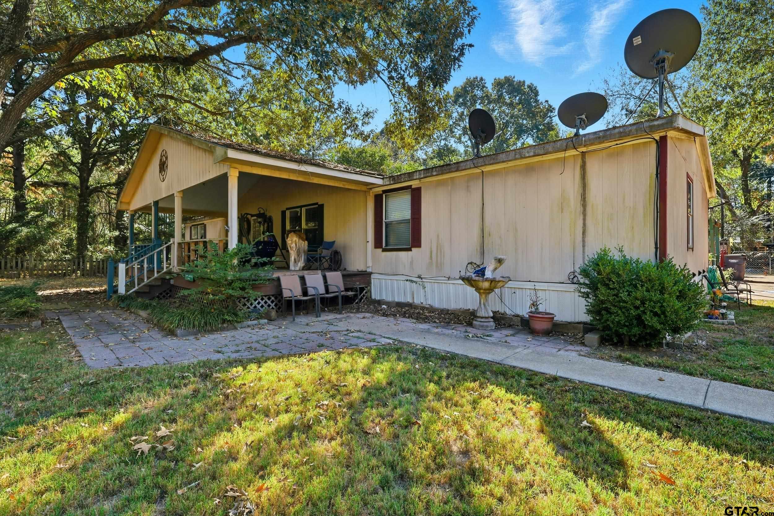 264 County Road 2169 Quitman, TX 75783 - Photo 9 of 34 a view of a house with backyard and sitting area
