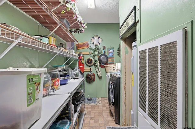 a spacious bedroom with a bed and a chandelier
