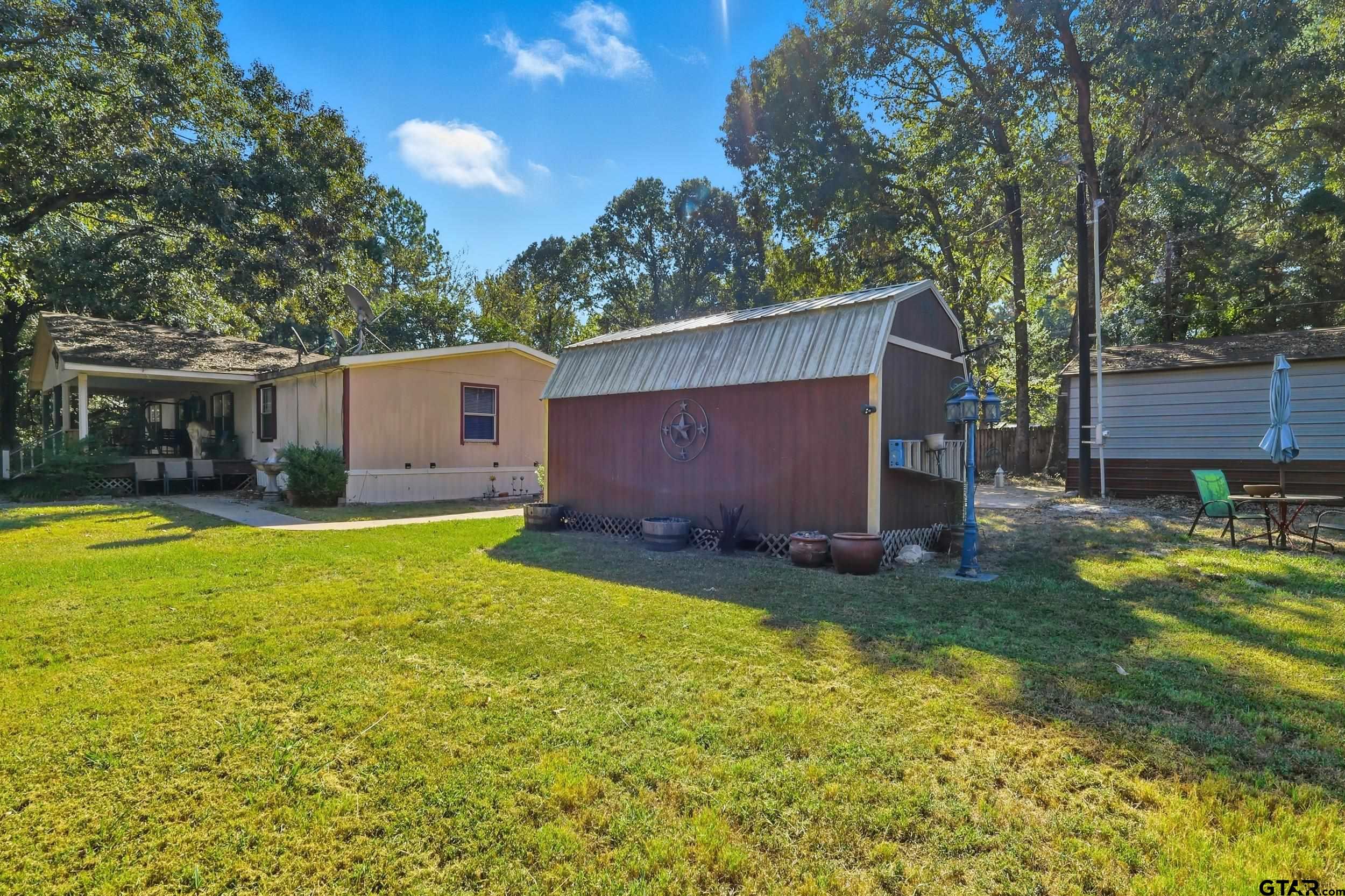 264 County Road 2169 Quitman, TX 75783 - Photo 10 of 34 a view of a backyard with a small cabin