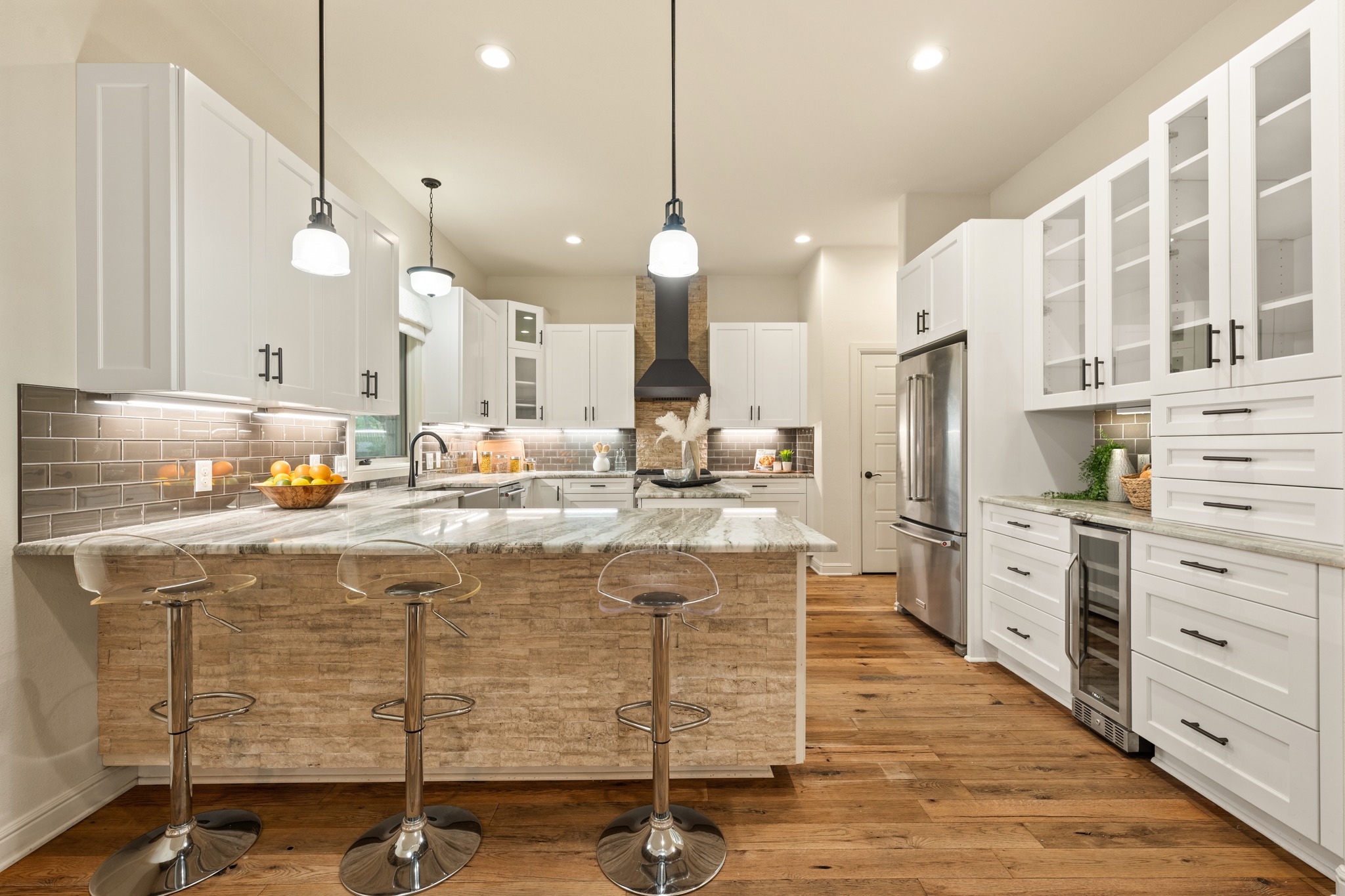 3907 Bailey Lane Austin, TX 78756 - Photo 9 of 40 The kitchen is an entertainer's paradise with an oversized breakfast bar, ample countertop space for prepping and serving, and an abundant amount of storage in the shaker style cabinetry