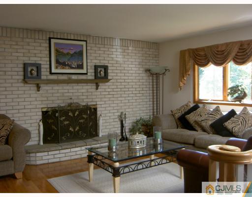 4 Kings Road East Brunswick, NJ 08816 - Photo 4 of 9 a living room with furniture and a fireplace