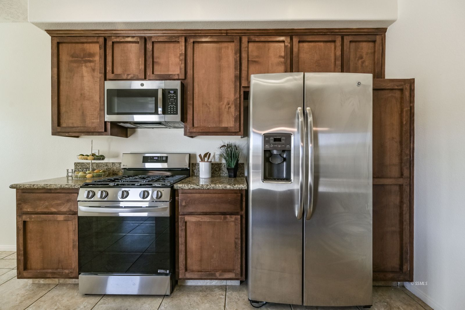320 South Inyo Street Ridgecrest, CA 93555 - Photo 24 of 42 a kitchen with stainless steel appliances granite countertop a refrigerator stove and microwave