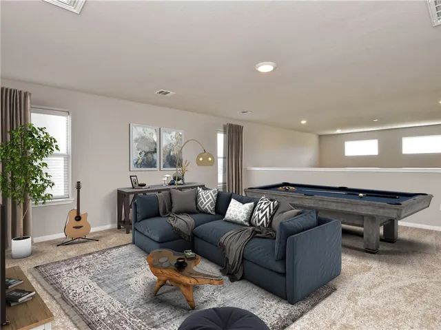 a living room with furniture and a potted plant
