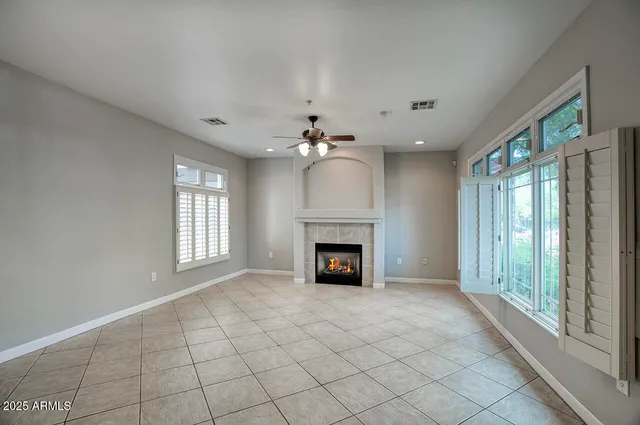 a view of an empty room with a fireplace and a window
