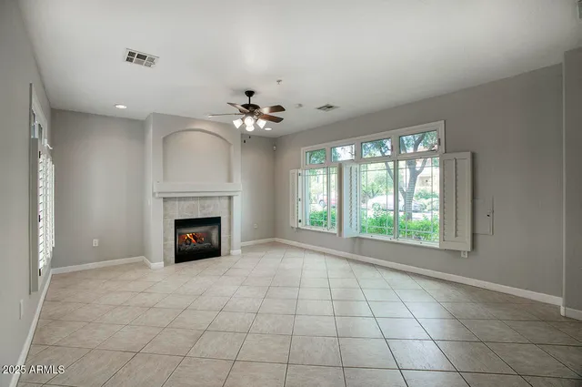 a view of an empty room with a fireplace and a window