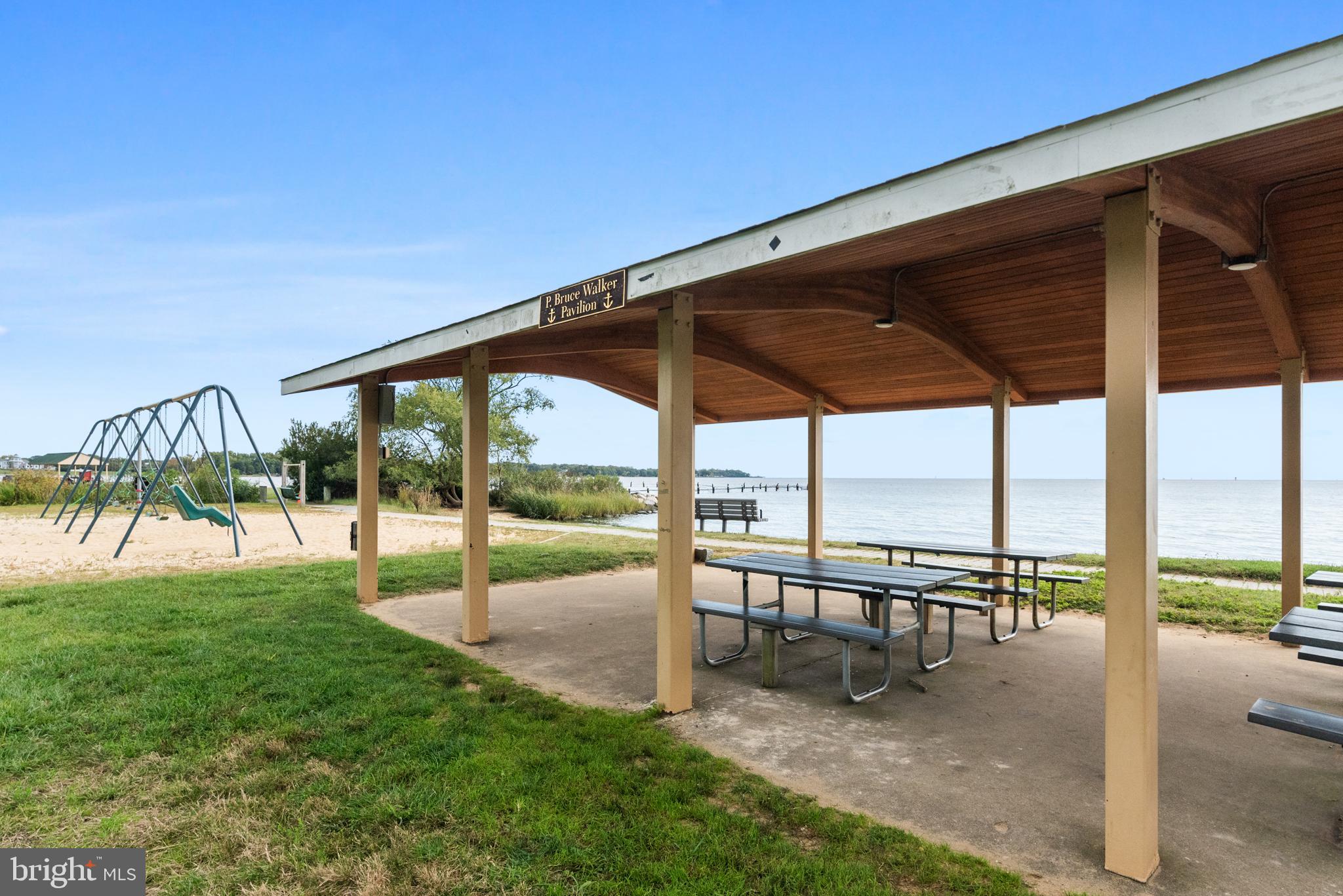 125 Pinecrest Drive Annapolis, MD 21403 - Photo 62 of 69 a view of a swimming pool with a table and chairs under an umbrella