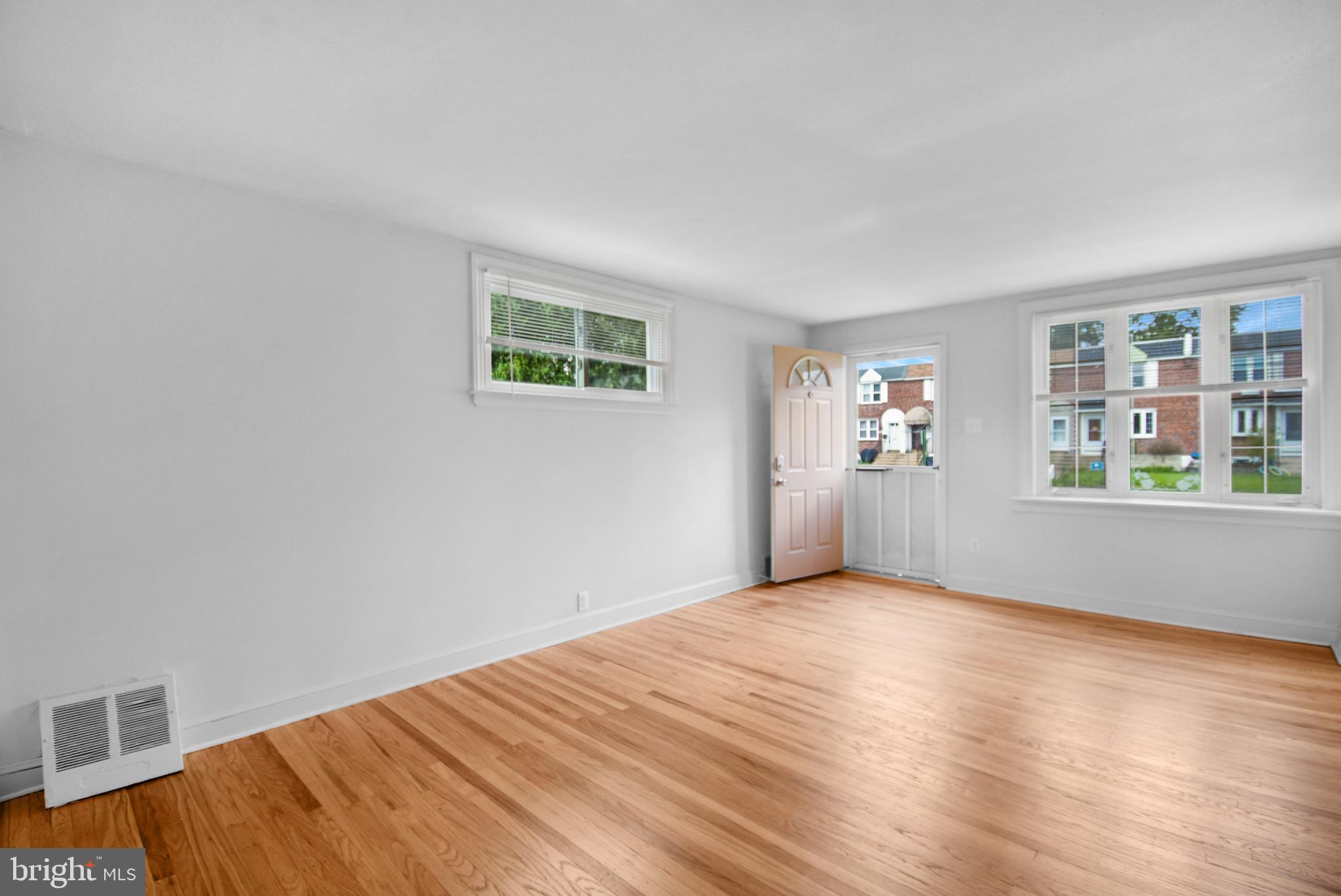 666 Rively Avenue Glenolden, PA 19036 - Photo 3 of 15 a view of an empty room with window and wooden floor